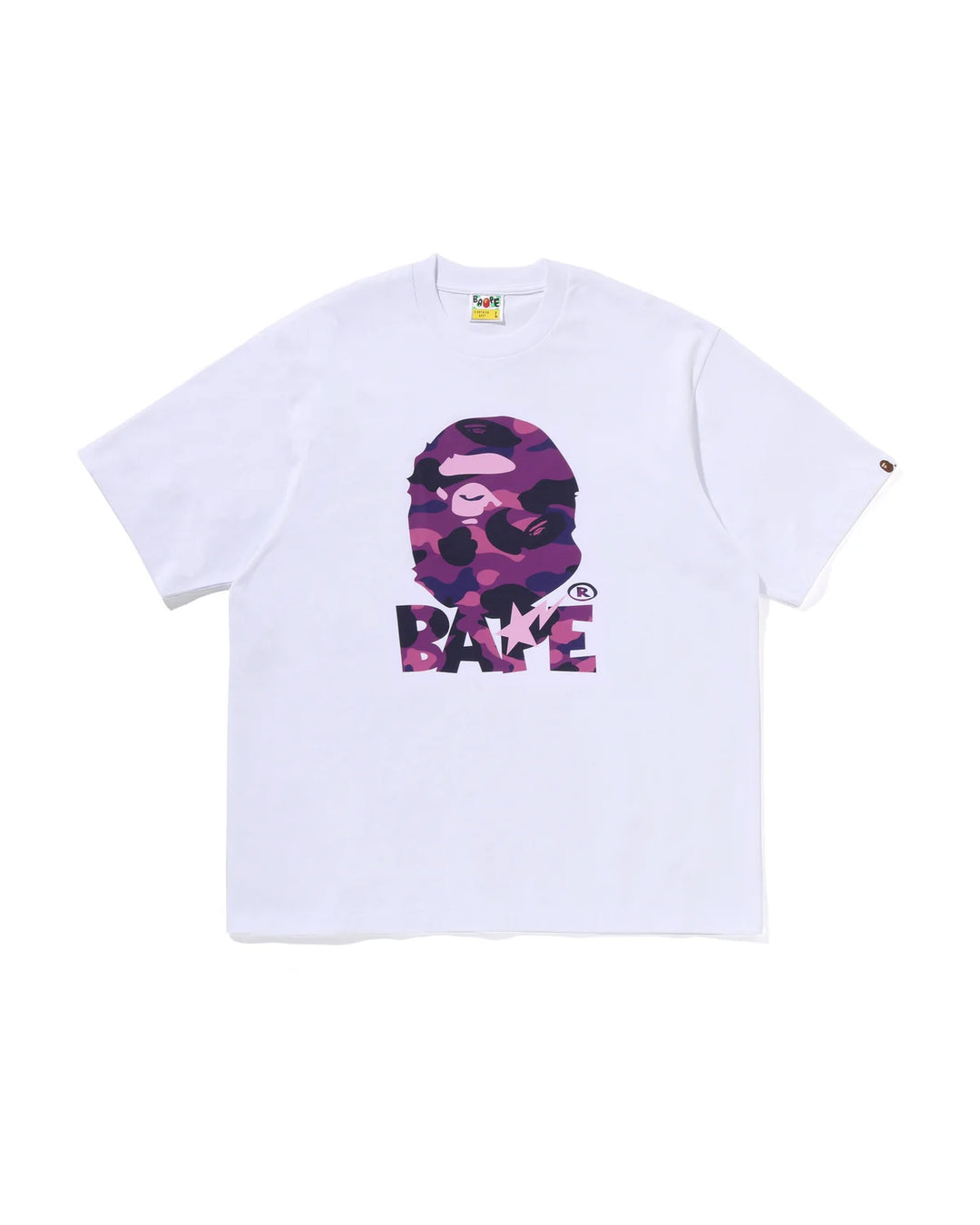 A white short-sleeve t-shirt featuring a large front graphic of the A Bathing Ape (BAPE) ape head in a pink and purple camouflage pattern above the word 'BAPE' in matching camouflage letters.
