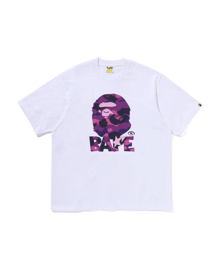A white short-sleeve t-shirt featuring a large front graphic of the A Bathing Ape (BAPE) ape head in a pink and purple camouflage pattern above the word 'BAPE' in matching camouflage letters.